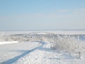 Beautiful winter landscape. The road is covered with snow and the village in the distance with snow-covered houses Royalty Free Stock Photo