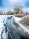 Beautiful Winter landscape scene background with snow covered trees and ice river Royalty Free Stock Photo