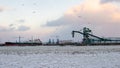 Beautiful winter landscape with ship in cargo port fuel terminal at sunset time., Ventspils, Latvia Royalty Free Stock Photo