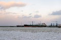 Beautiful winter landscape with ship in cargo port fuel terminal at sunset time., Ventspils, Latvia Royalty Free Stock Photo