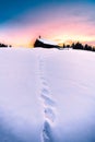 Beautiful winter landscape with snow covered alpine house at sunset, Seiser Alm, Trentino-Alto Adige, Italy. Royalty Free Stock Photo