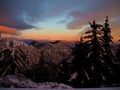 Beautiful winter landscape with snow-covered trees and mountains in the background at sunset Royalty Free Stock Photo