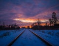 A beautiful winter landscape with train tracks during sunset. Royalty Free Stock Photo