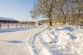 Beautiful winter landscape view. Horse trailer parked near stable.