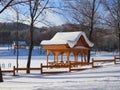 Beautiful winter landscape with a wooden pergola covered with a thick layer of snow on a Sunny frosty day Royalty Free Stock Photo