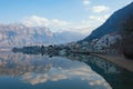 Beautiful winter Mediterranean landscape - mountains, blue sky with white clouds and reflection in the water. Montenegro Royalty Free Stock Photo