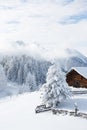 Beautiful winter mountain landscape with snowcapped wooden chalet. Austrian Alps