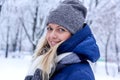 Beautiful winter portrait of young woman in the winter snowy scenery. Beautiful girl in winter clothes. Royalty Free Stock Photo