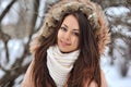 Beautiful winter portrait of young woman in the winter snowy scenery