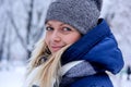 Beautiful winter portrait of young woman in the winter snowy scenery. Beautiful girl in winter clothes. Royalty Free Stock Photo