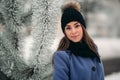 Beautiful winter portrait of young woman in the winter snowy scenery Royalty Free Stock Photo
