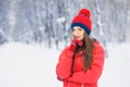 Beautiful winter portrait of young woman in the winter snowy scenery. Royalty Free Stock Photo