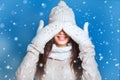 Beautiful winter portrait of young woman in the winter snowy scenery . Snowing winter beauty concept. Girl closes eyes with her ha Royalty Free Stock Photo