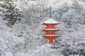 Beautiful winter season of Red Pagoda at Kiyomizu-dera temple surrounded with trees covered white snow background. Royalty Free Stock Photo