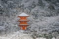 Beautiful winter seasonal of Red Pagoda at Kiyomizu-dera temple surrounded with trees covered white snow background. Royalty Free Stock Photo