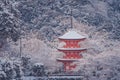 Beautiful winter seasonal of Red Pagoda at Kiyomizu-dera temple surrounded with trees covered white snow background at Kyoto. Royalty Free Stock Photo