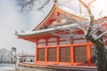 Beautiful winter seasonal of Red Pagoda at Kiyomizu-dera temple surrounded with trees covered white snow background at Kyoto. Royalty Free Stock Photo