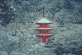 Beautiful winter seasonal of Red Pagoda at Kiyomizu-dera temple surrounded with trees covered white snow background. Royalty Free Stock Photo