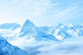 beautiful winter snow covered peaks of Caucasus mountain, Dombaj over clouds, Russia, close up Royalty Free Stock Photo