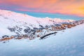 Beautiful winter sunrise landscape, famous ski resort with typical alpine wooden houses in French Alps, Les Menuires, 3 Vallees, Royalty Free Stock Photo