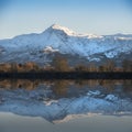 Beautiful Winter sunrise landscape image of Mount Snowdon and ot