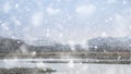 Beautiful Winter sunrise landscape image of Mount Snowdon and other peaks in Snowdonia National Park in heavy snow storm