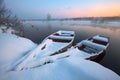 Beautiful winter sunrise at the river. The boats in snow at the river Royalty Free Stock Photo