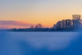 A beautiful winter sunrise scenery of frozen lake and forest. Colorful landscape with dawn skies Royalty Free Stock Photo