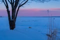 A beautiful winter sunrise scenery of frozen lake and forest. Colorful landscape with dawn skies Royalty Free Stock Photo