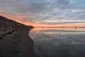 Beautiful winter sunset at lake, lake sunset and sand, reflection clouds Royalty Free Stock Photo