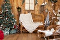 Beautiful winter terrace of the house with bench and Christmas tree with gifts. Wooden verande with Christmas decor Royalty Free Stock Photo
