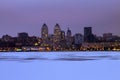 Beautiful winter view of the Dnepr city in the evening, the ice of the frozen Dnieper river is covered with fresh snow.