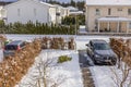 Beautiful winter view of modern village with cars parked in private parking lots in garden.