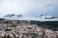 Beautiful Winter View Over a Snowy Mountain. Snow clouds over a city in the snowy mountains Royalty Free Stock Photo