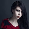 Beautiful witch and Halloween theme: portrait of a girl vampire with black hair Royalty Free Stock Photo