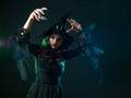 Beautiful witch with a hat make spell. Halloween party, witches ` Sabbath. Royalty Free Stock Photo