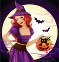 Beautiful witch hold a funny pumpkin