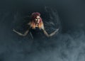 Beautiful witch making the witchcraft over the smoky background Royalty Free Stock Photo