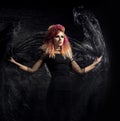 Beautiful witch making the witchcraft over the smoky background Royalty Free Stock Photo