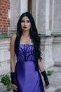 Beautiful witch in purple dress