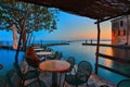 Beautiful woman admiring the Sunset, Punta San Vigilio harbour at Garda Lake, Italy