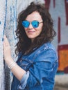 Beautiful woman against concrete wall