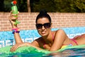 Beautiful woman on airbed sunbathing