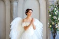 Beautiful woman with angel wings inspires beauty