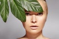 Beautiful woman applies Organic Cosmetic. Spa and Wellness. Model with Clean Skin. Healthcare. Picture with leaf Royalty Free Stock Photo