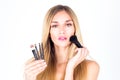 Beautiful woman applying blush on the face. Make-up artist. Royalty Free Stock Photo