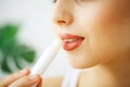 Beautiful woman applying hygienic lip balm. Royalty Free Stock Photo