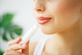 Beautiful woman applying hygienic lip balm. Royalty Free Stock Photo