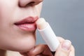 Beautiful woman applying hygienic lip balm. Royalty Free Stock Photo