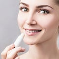 Beautiful woman applying hygienic lip balm. Royalty Free Stock Photo